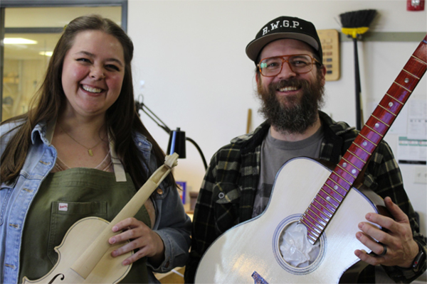 Abbie Fields and Ethan Lee Sandler hold musical instruments