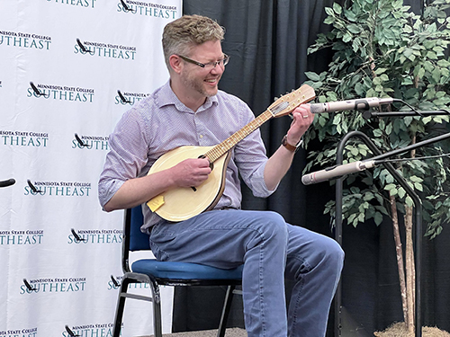 Mike Cramer playing a mandolin