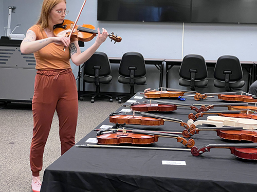 A student playing a violin