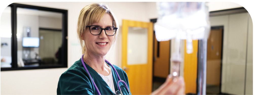 Nursing student holding IV bag