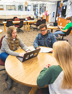 Students at table in The Roost