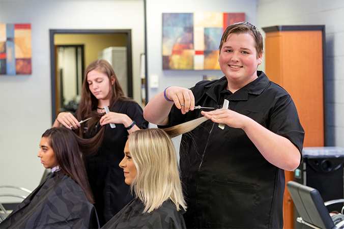 Cosmetologists cutting hair