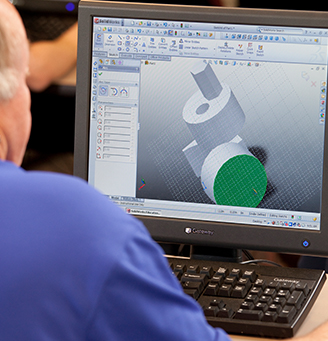 Man viewing 3D rendering on a computer screen