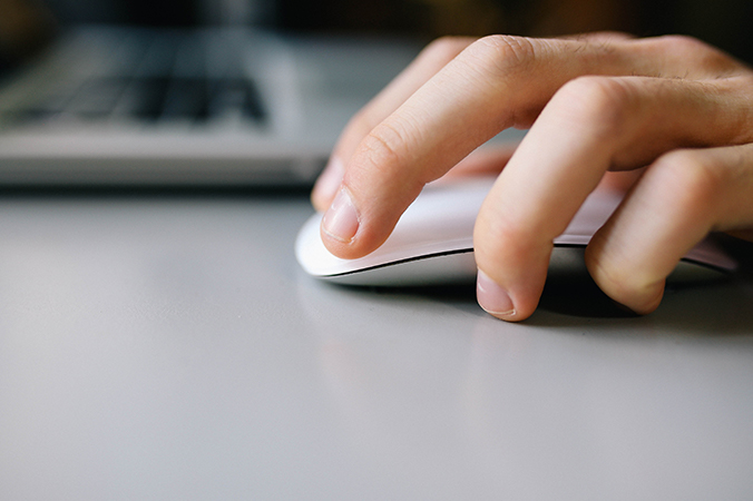 A hand working a computer mouse