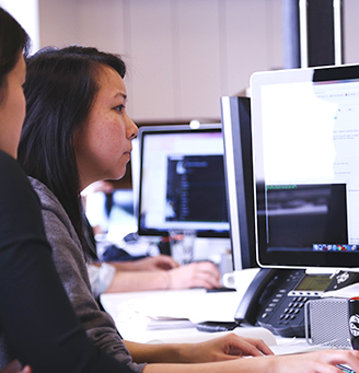 Two coders working at a computer