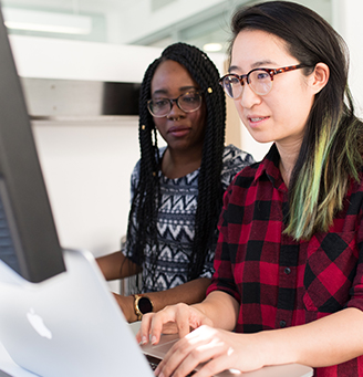 Two women working at a computer - Cristina Morillo via Pexels