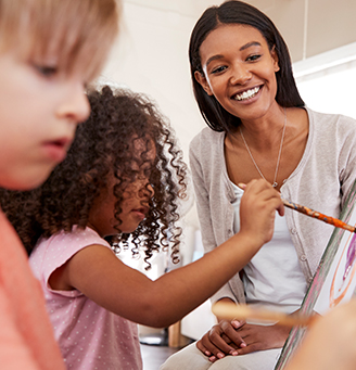 Instructor with children painting