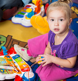 Young girl playing with toys