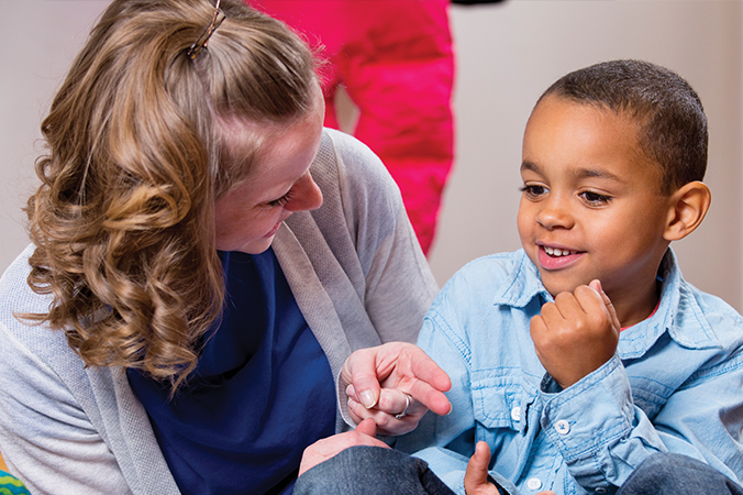 Teacher talking to a young boy