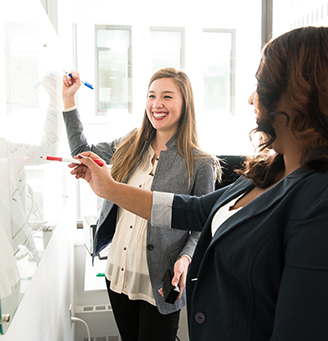 Coworkers at working at a whiteboard - photo by Christina Morillo from Pexels