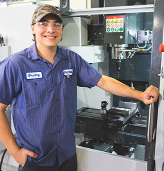 Student holing calipers in a tool shop