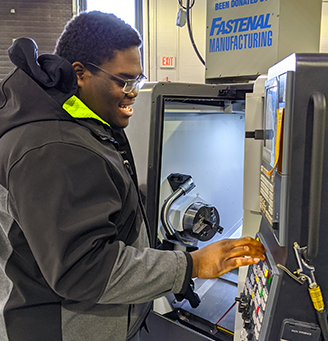 Student working at metal lathe