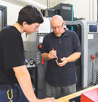 Tech working at a CNC machine