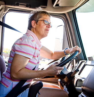 Student driver behind the wheel - inside a truck's cab'