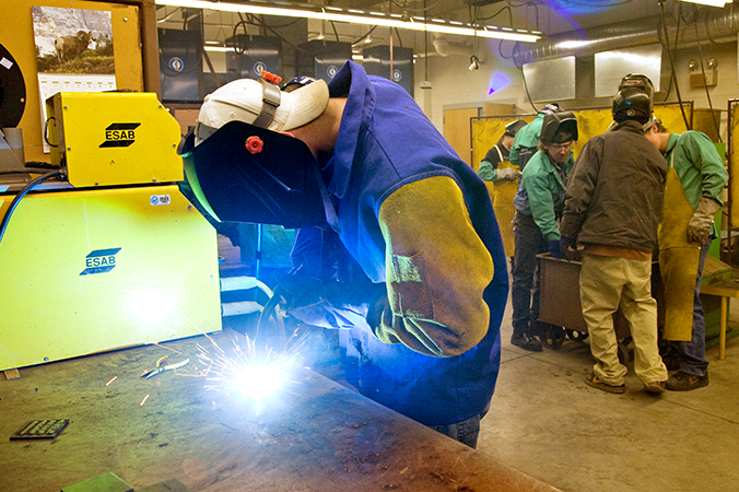 Student welding in a shop