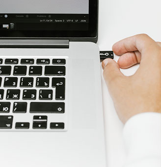 Person inserting external drive into laptop - Photo by cottonbro studio, Pexels.com