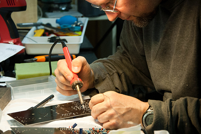 Technician soldering a circuit board