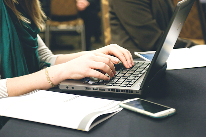 Close up of person typing at a laptop